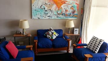 Family Apartment, 2 Bedrooms, Pool View | Living room | 50-inch flat-screen TV with cable channels, TV