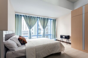 A modern hotel room with a large bed, a desk, and a wardrobe. - StayHome Asia at Two Central (Makati)