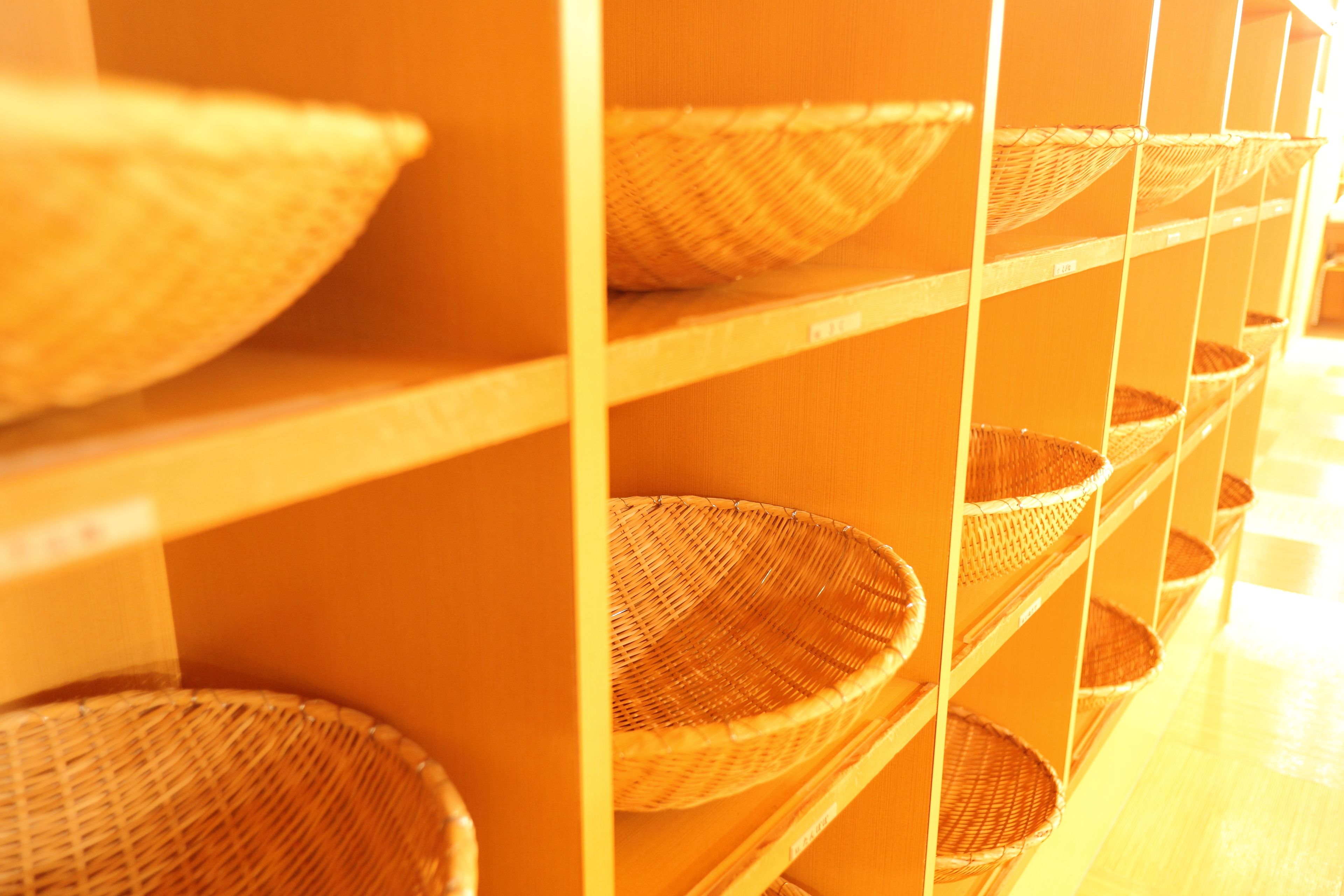 Wicker baskets on shelves in a room.