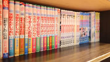 A shelf with a row of books with Japanese text.
