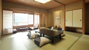 A traditional Japanese-style room with tatami flooring, a low table, and sliding doors.