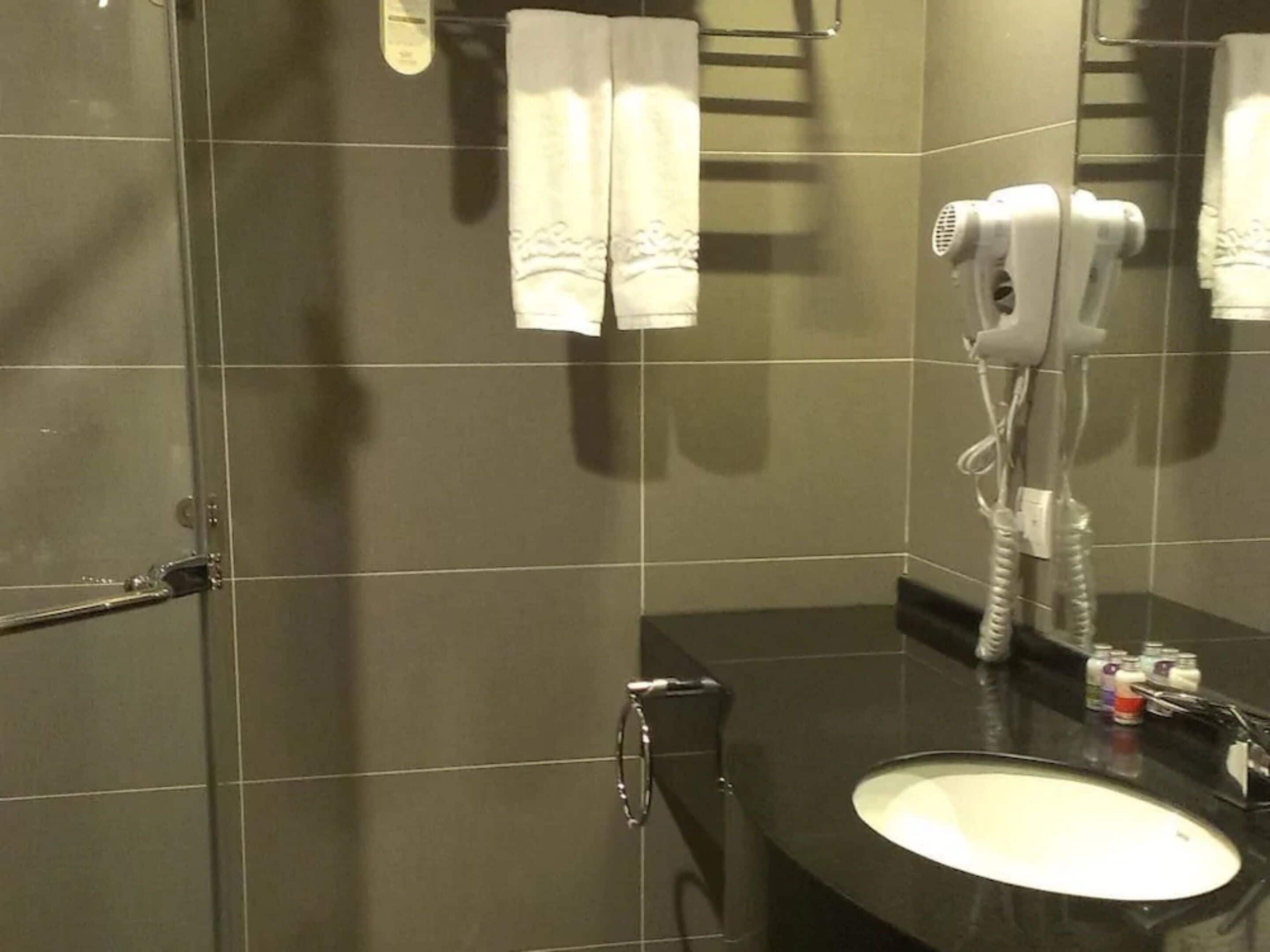 hair dryer, slippers, bidet, towels