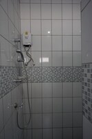 A shower with a handheld showerhead, a wall-mounted faucet, and a control panel.
