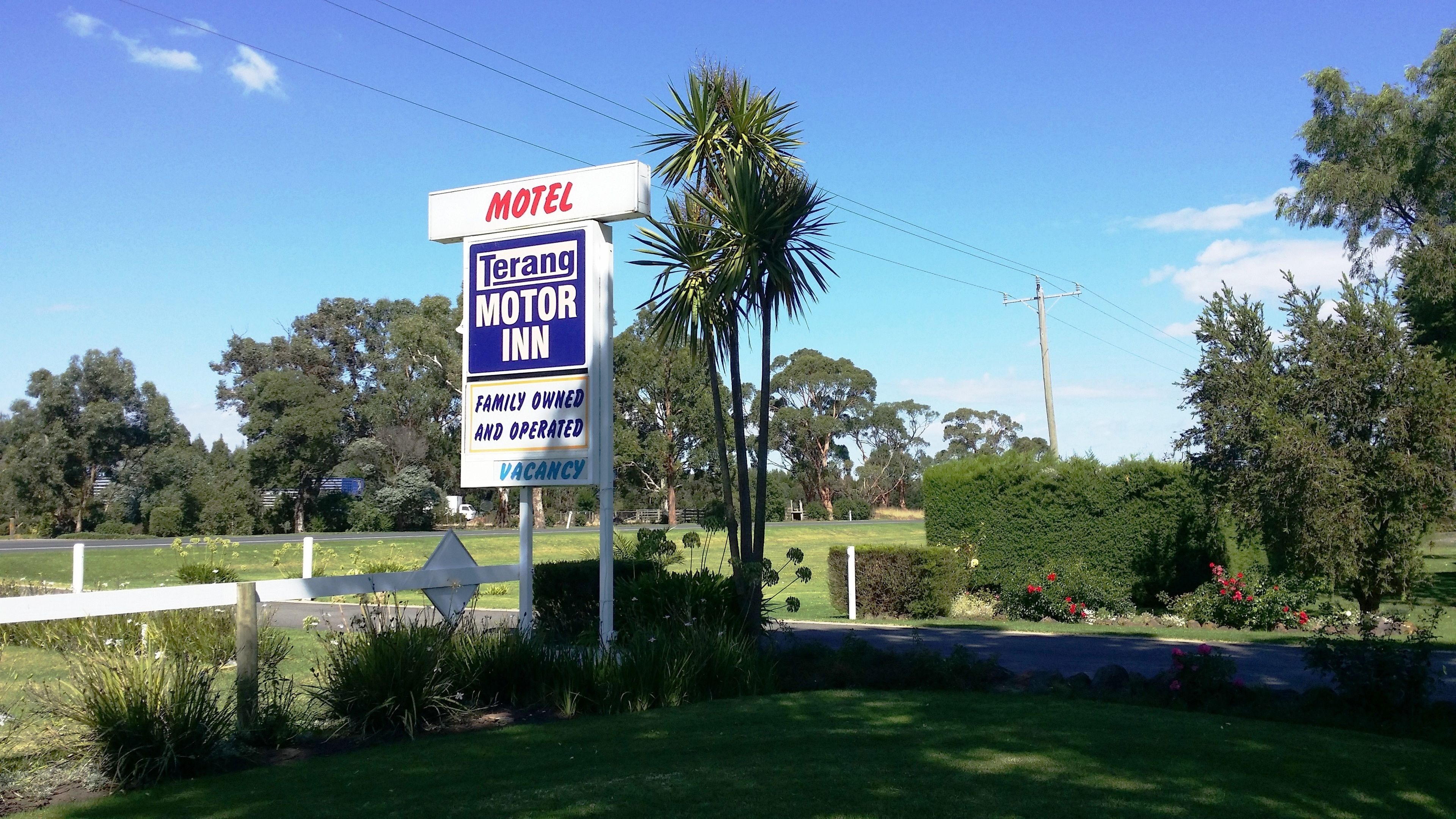 A motel sign with the name 'Terang Motor Inn' and a 'VACANCY' notice.