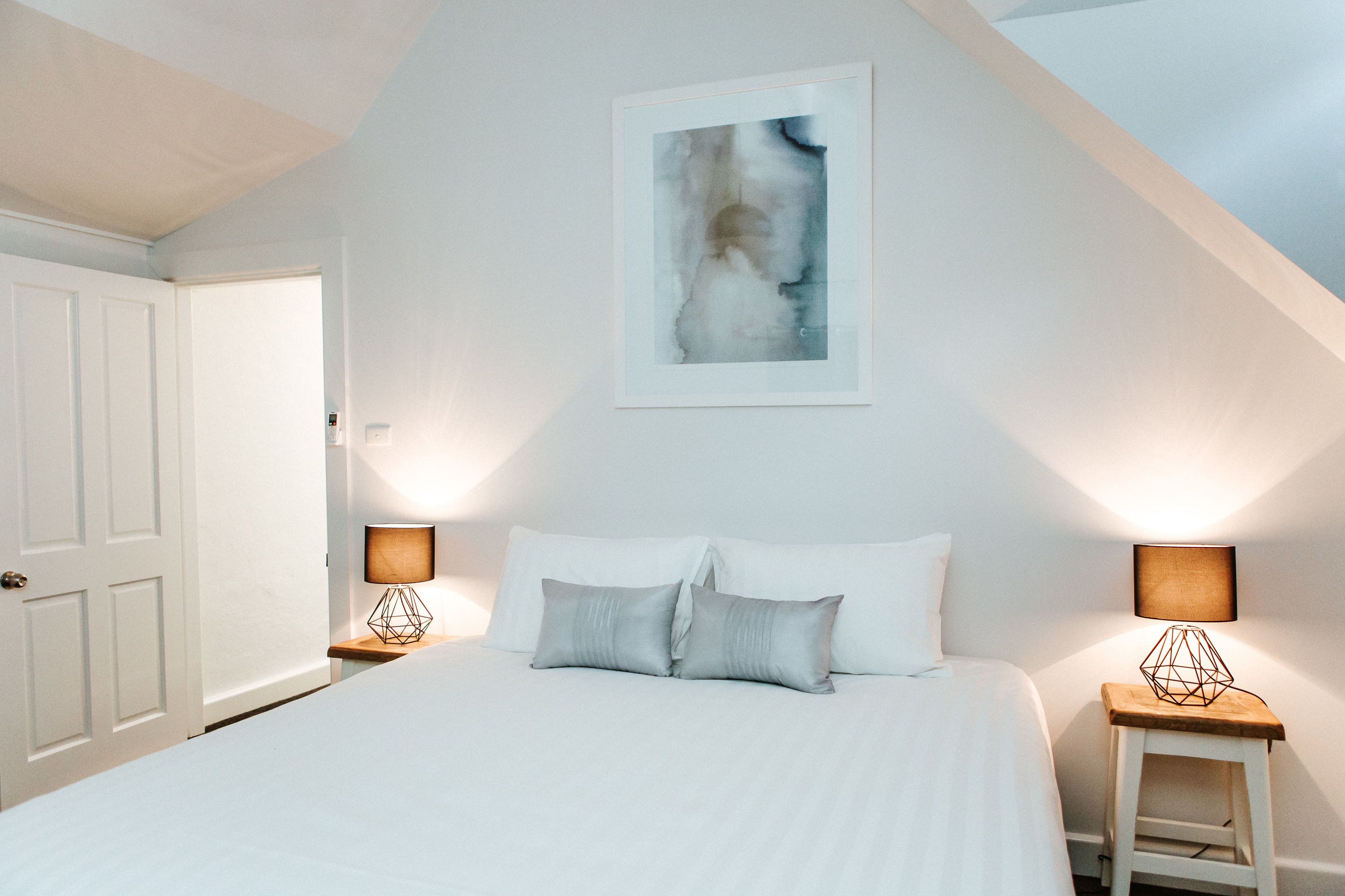 one or two bedroom king suite | premium bedding, desk, laptop workspace, iron/ironing board