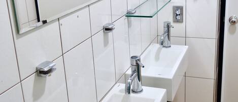 Shower, hair dryer, slippers, towels