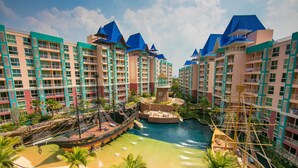 A resort with multiple buildings, a central water feature, and a pirate ship.
