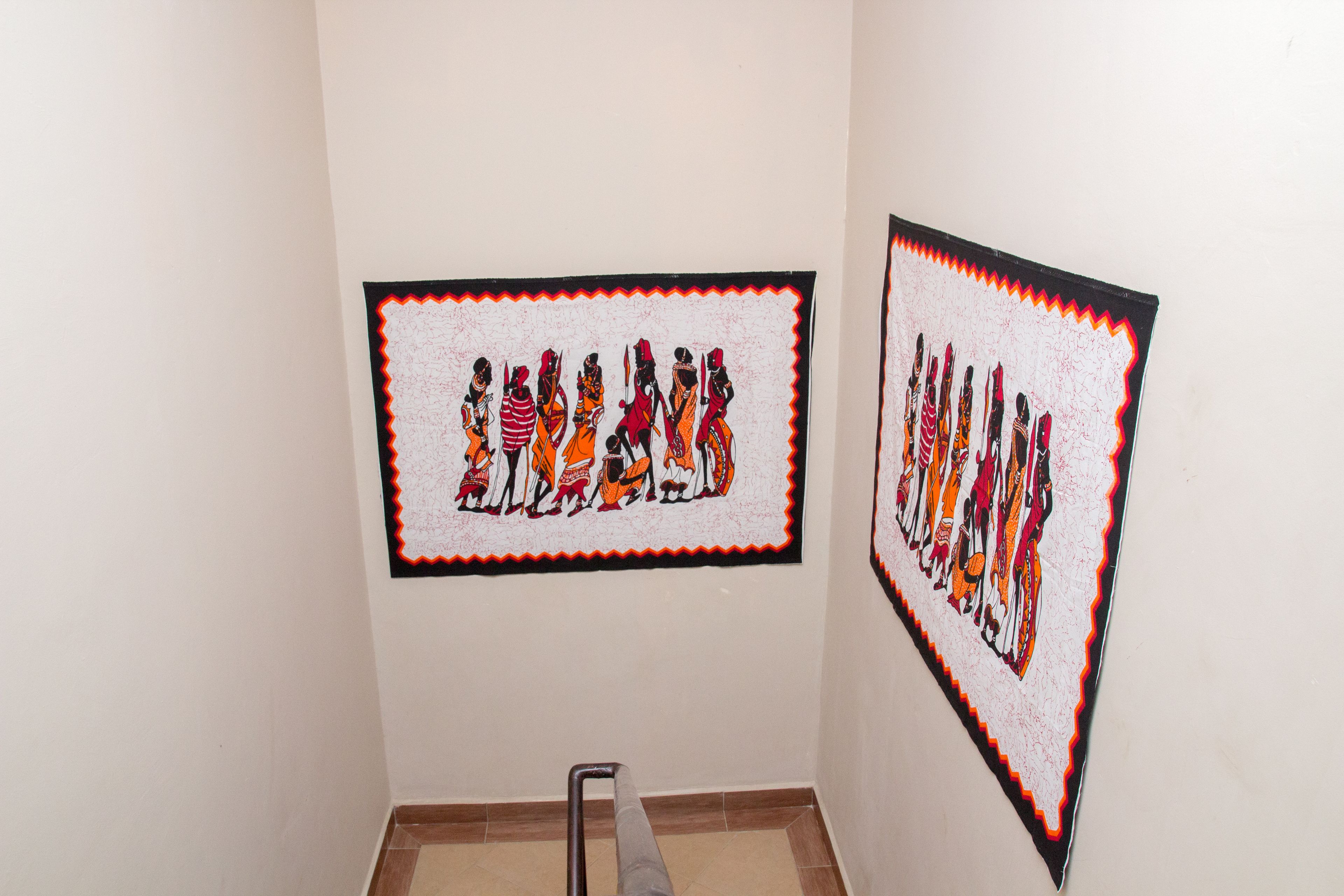 Two framed artworks on a wall.