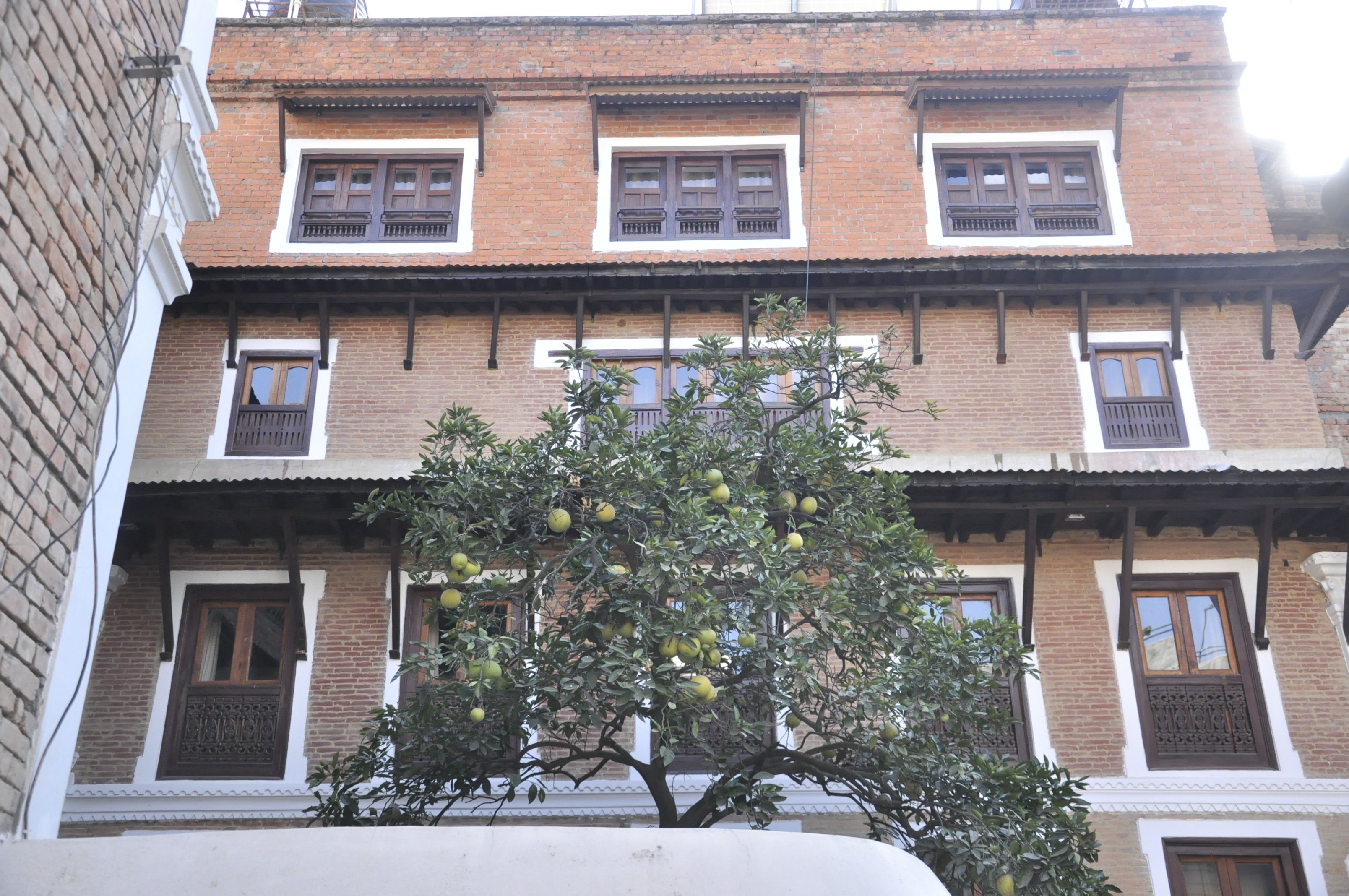A multi-story building with traditional brickwork and wooden window frames.