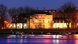 A historic building with arched windows and a waterfront view. - The Quigley Residence (Garraun)