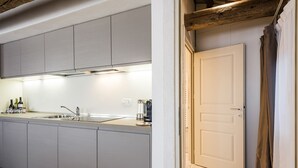 A modern kitchen with grey cabinets, a stainless steel sink, and a coffee machine. - MYSWEETPLACE - San Marco Apartments (Venice)
