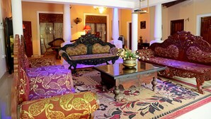 A traditional living room with ornate sofas, a glass coffee table, and a patterned carpet. - The Castle (Seeduwa - Katunayake)