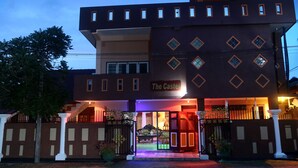 A building with a sign reading "The Castle" at the entrance, featuring a gated driveway and a well-lit facade. - The Castle (Seeduwa - Katunayake)