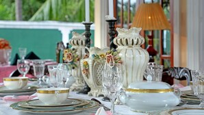 A table set with fine china, glassware, and elegant tableware, suggesting a formal dining experience. - The Castle (Seeduwa - Katunayake)