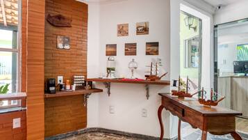 A cozy room with a wooden accent wall, a coffee station, and nautical-themed decor.