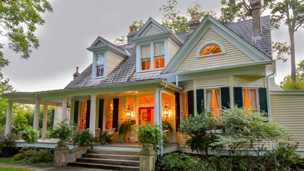 A two-story house with a porch, steps leading to the entrance, and a chimney. - Clermont Bluffs B&B (Natchez)