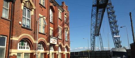 A red brick building with a sign for 'West of England Tavern'.