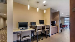 A modern hotel room with a desk, two chairs, a flat-screen TV, a computer, and a coffee station. - Comfort Suites Denver near Anschutz Medical Campus (Aurora)
