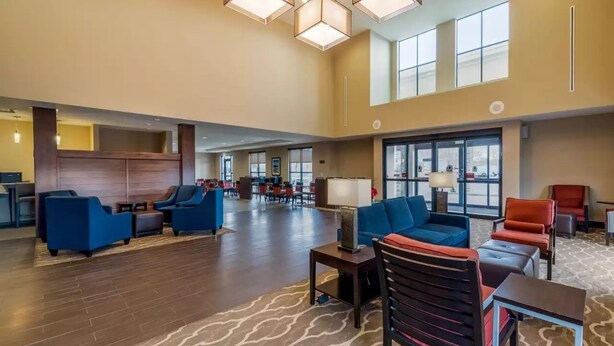 A spacious lobby with multiple seating areas, large windows, and a high ceiling. - Comfort Suites Denver near Anschutz Medical Campus (Aurora)