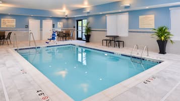 Relax by the pool, surrounded by comfortable seating and lush greenery.