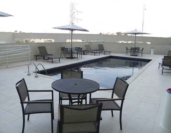 Outdoor pool, open 9:00 AM to 9:00 PM, pool umbrellas, pool loungers