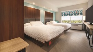 A hotel room with two beds, a desk, and a large window with a view. - Tru by Hilton Lancaster East (Lancaster)