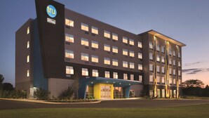 A modern hotel building with a prominent 'tru' logo, multiple floors, and a well-lit entrance. - Tru by Hilton Lancaster East (Lancaster)