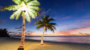 On the beach, white sand, beach towels, beach bar