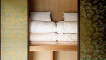 A bed with white bedding in a room with wooden headboard and walls.