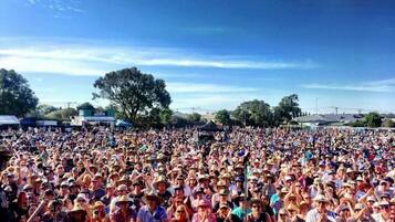A large outdoor gathering with a stage and audience.
