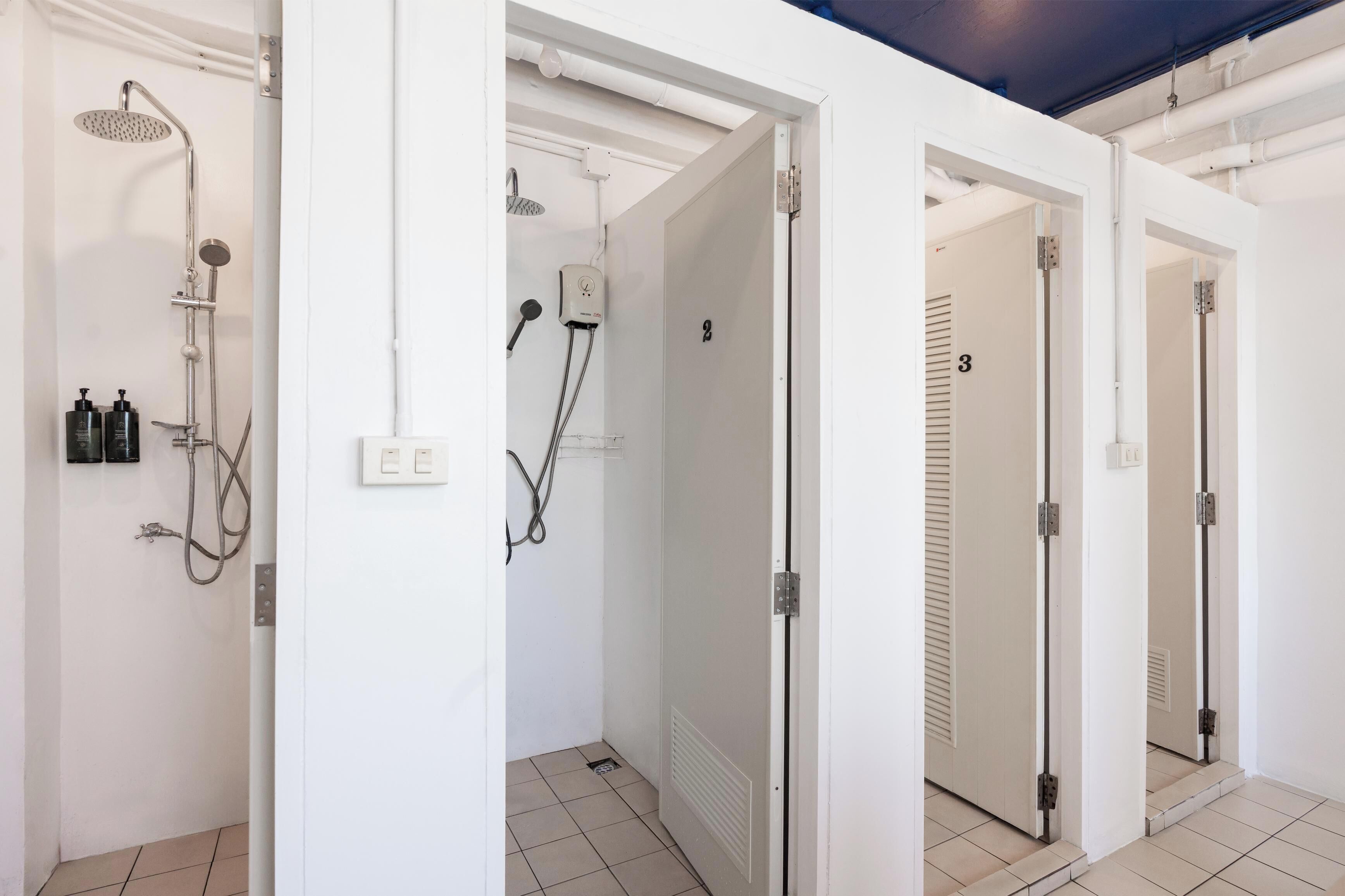 A modern bathroom with a shower, a toilet, and a sink.