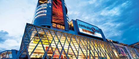 A modern hotel with a prominent glass facade, a central atrium, and a distinctive tower structure.