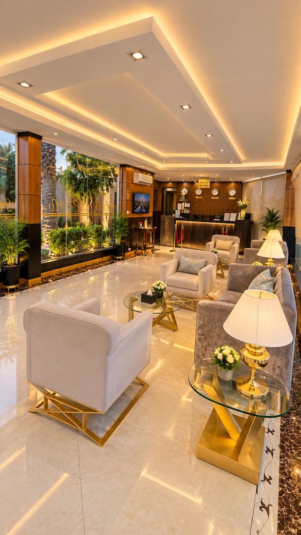 A hotel lobby with a reception desk, seating area, and a reception counter.
