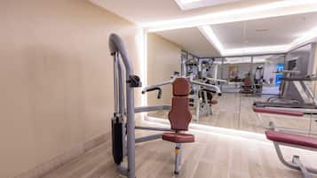 A gym with various exercise equipment, including a bench press and a leg press.