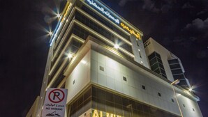 The Al Muhaidb Hotel with a "No Parking" sign, modern architecture, and illuminated signage. - Al Muhaidb Residence Al Malaz 2 - Economic (Riyadh)