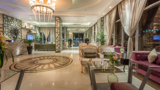 A spacious lobby with a grand chandelier, plush seating, and a modern reception desk. - Al Muhaidb Residence Al Malaz 2 - Economic (Riyadh)
