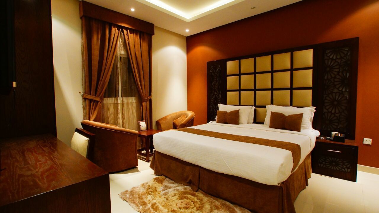 Apartment, 1 Bedroom | Minibar, in-room safe, desk, iron/ironing board