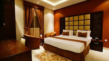 Apartment, 1 Bedroom | Minibar, in-room safe, desk, iron/ironing board