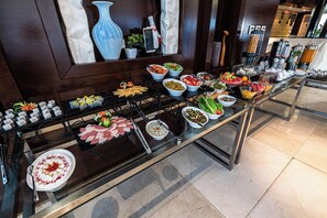 A buffet setup with various food items and a menu board. - AL Muhaidb ResidenceAl Olaya 1 - Economic (Riyadh)