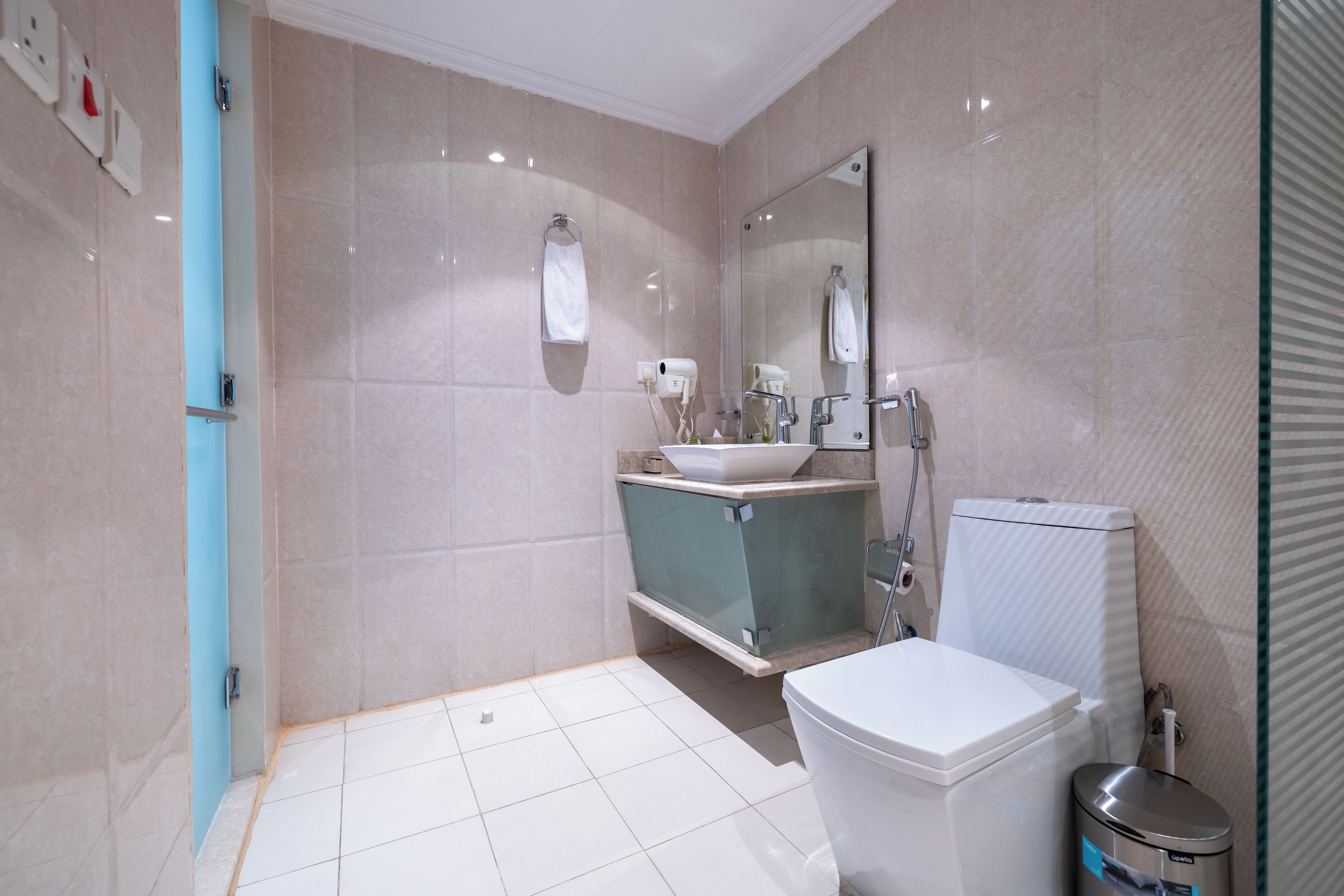 A modern bathroom with a toilet, sink, and shower.