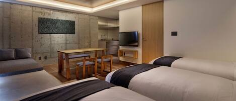 A modern hotel room with a dining area, a TV, and a large artwork on the wall.