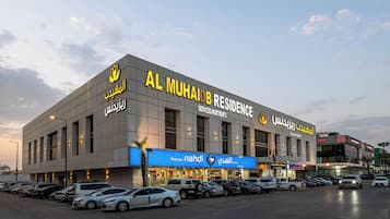 A building with multiple floors, a pharmacy, and a car rental service.