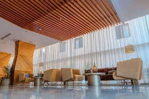 A modern lobby with a wooden slatted ceiling, large windows, and contemporary furniture. - AL Muahidb Residence Al Takhasossi 5 - Economic (Riyadh)