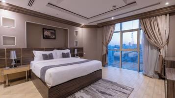 A modern bedroom with a large bed, a city view, and a wooden headboard.