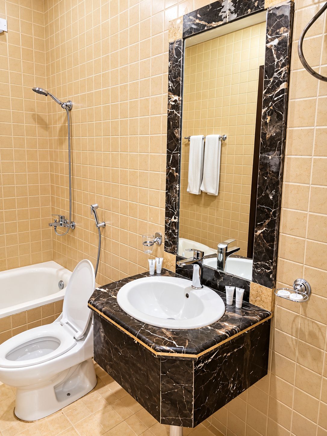 A bathroom with a bathtub, a toilet, a sink, and a shower.