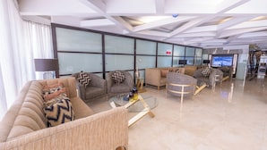 A modern living room with a sofa set, a coffee table, and a television.