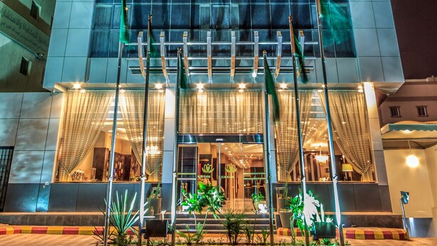 The exterior of the Al Muhaiidb Hotel with its illuminated signage and entrance. - Al Muhaidb Residence Al JAWAZAT  1 - Economic (Riyadh)