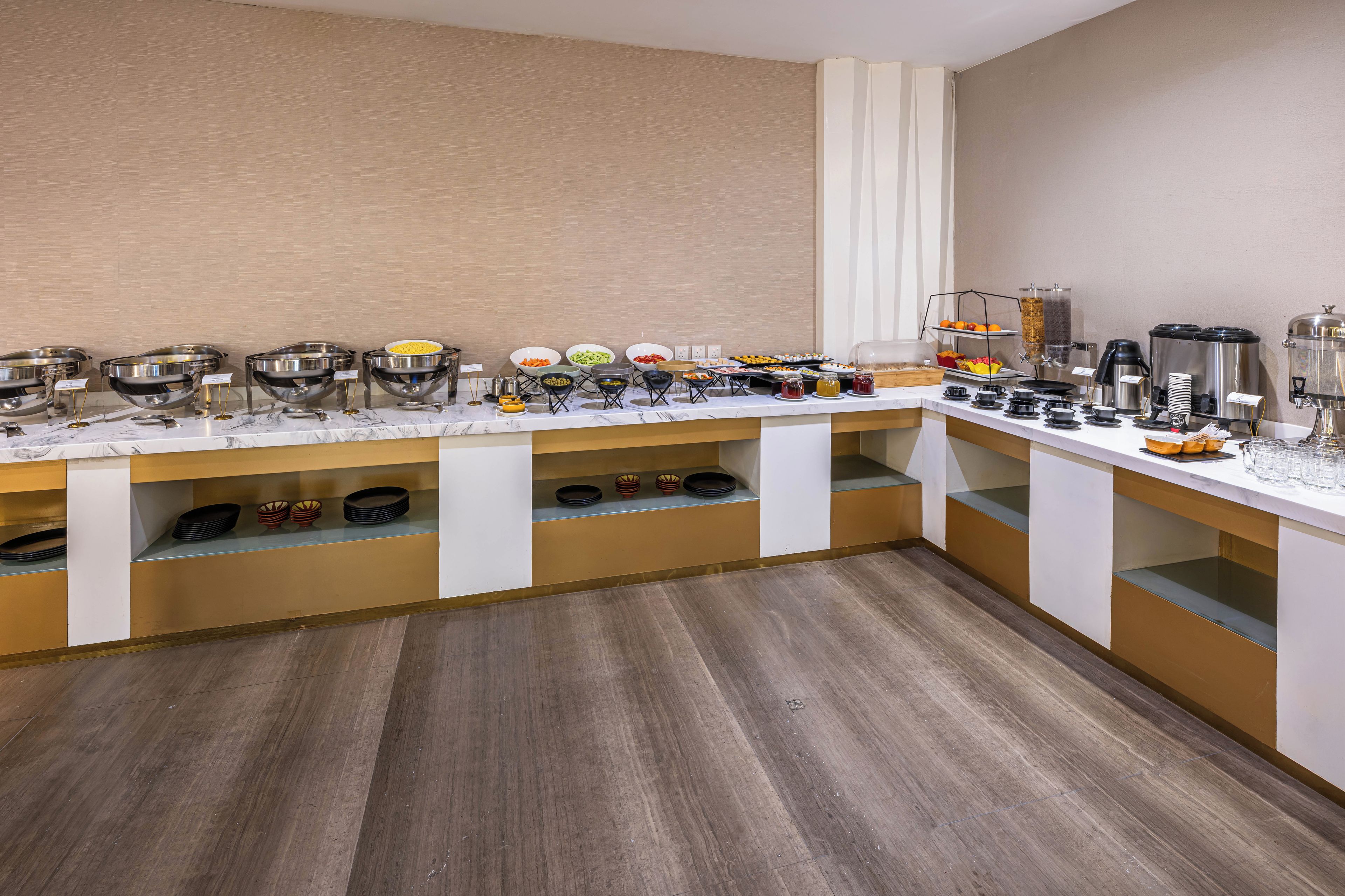A buffet setup with various food items and beverages.