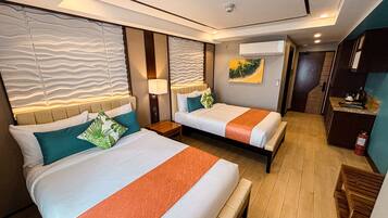 A hotel room with two beds, a nightstand, a desk, and a painting on the wall.