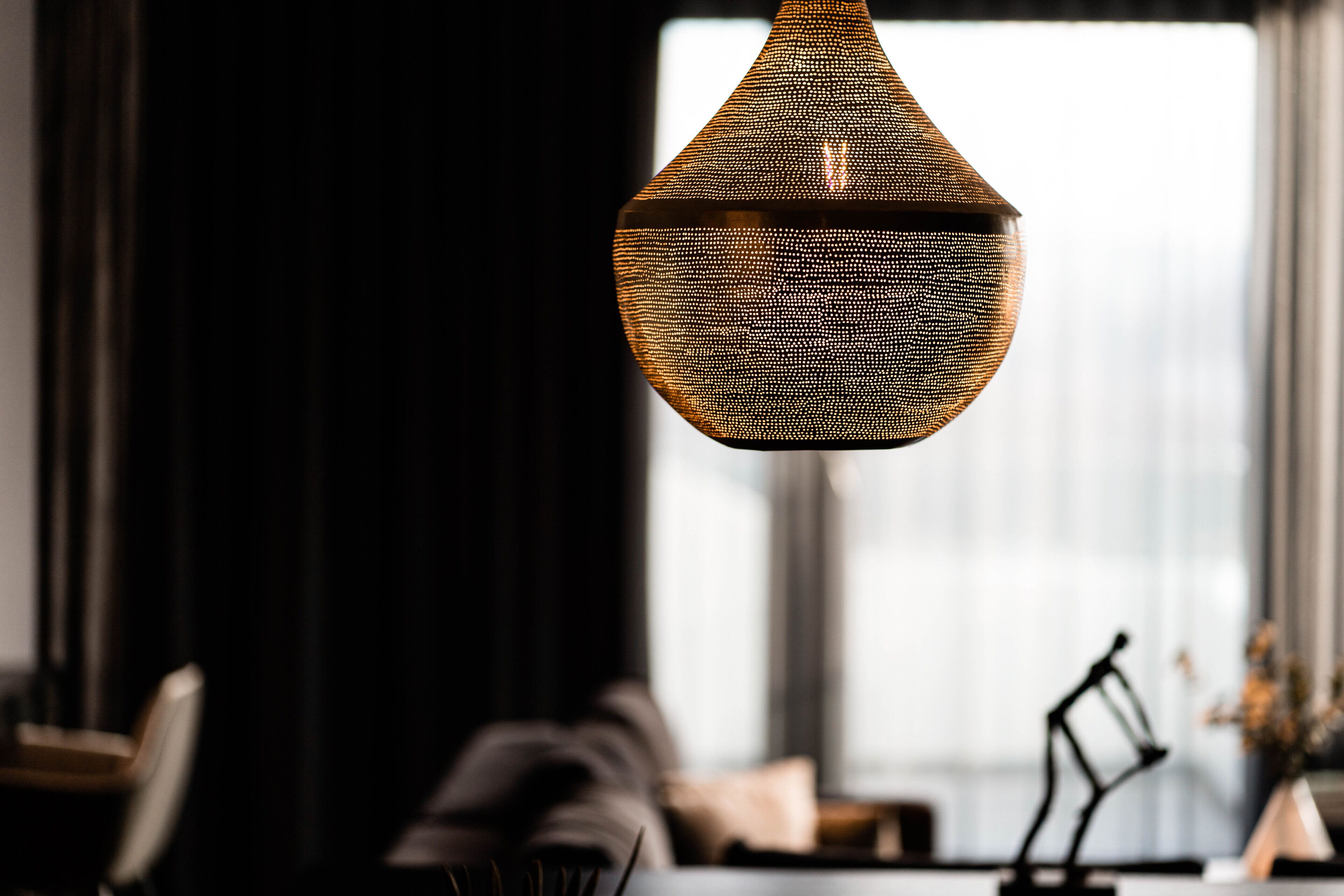 A hanging light fixture with a textured pattern.